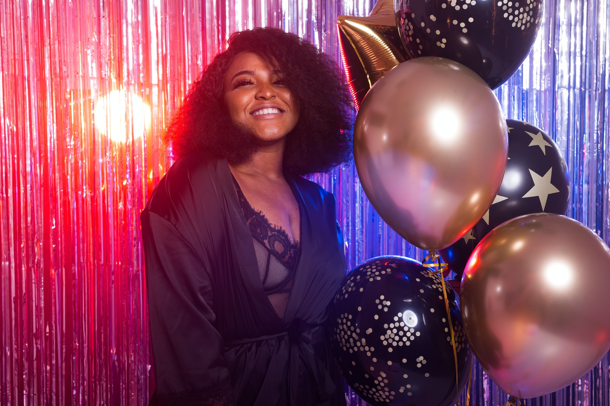 Portrait of a beautiful african american woman against twinkling background. Birthday party